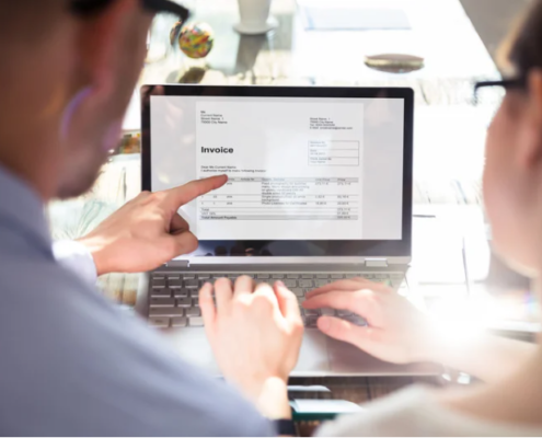 Business professional sending Peppol invoices via accounting software on laptop